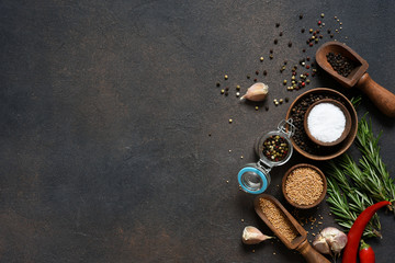 Various spices and herbs on a stone table. Top view with copy space.