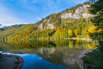 Peaceful autumn Alps mountain lake with clear transparent water and reflections. Langbathseen lake, Upper Austria.