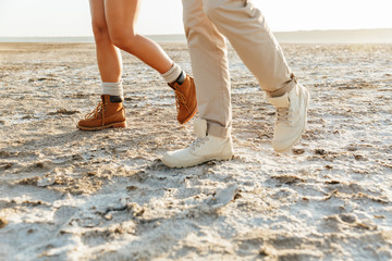 Couple outdoors at beach walking.