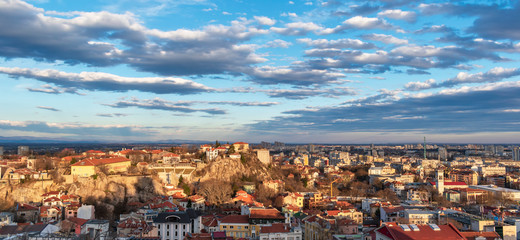 Plovdiv, Bulgaria. Panoramic view of the old and modern city and the picturesque sky with clouds. Aerial panorama. City landscape during sunset. Travel and tourist destinations concept.