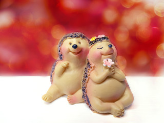 valentine's day card with hedgehogs couple toys on bokeh background