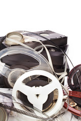 Vintage film camera rolls, old audio and video casettes with tape and foto strip isolated on a...