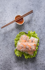 Vietnamese food spring rolls with vegetables, shrimps on grey stone background. Asian cuisine.