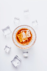 glass of whiskey with ice on a white background with place for text
