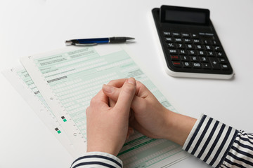 close up of hands filing a tax declaration