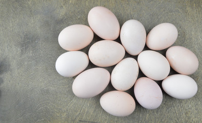  fresh home-made eggs lie on a wooden table
