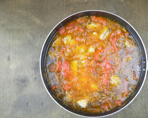 tasty liquid roast with meat and vegetables lies in a pan