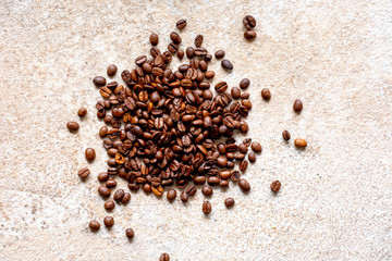 Fresh coffee beans on a stone surface