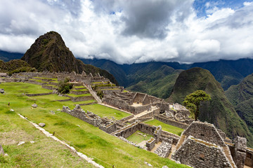 Fototapeta na wymiar The ruins of the ancient city of Machu Picchu, Peru. Close up, clouds.