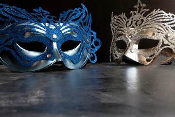 blue and silvery carnival masks on dark