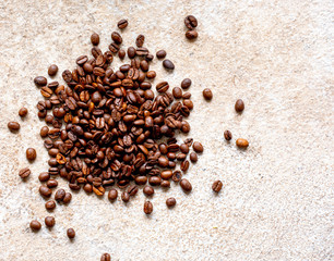 Fresh coffee beans on a stone surface