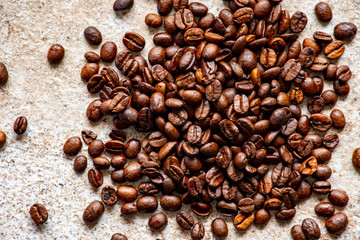 Fresh coffee beans on a stone surface