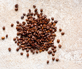 Fresh coffee beans on a stone surface