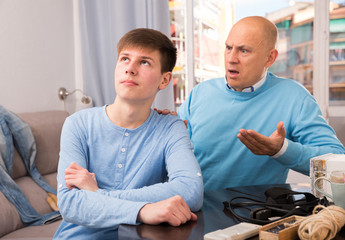 Man scolding his teenage son