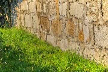 Stone made garden fence and grass
