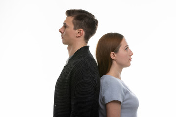 Portrait of a man and a woman standing with their backs to each other