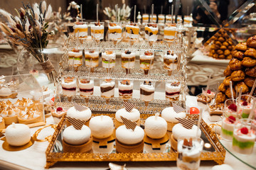  Wedding candy bar rich served, white cookies and chocolates and macaroons. Candy bar with balls, candy bar on holiday, candy bar at the wedding