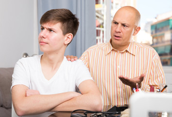 Man scolding son at home