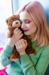 Portrait of a happy girl with toy bear