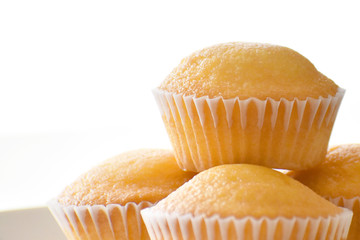 Muffin on a white plate on white background with copy space. Selective focus 