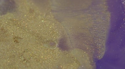 Abstract Acrylic gold and pastel violet Color Flow, Liquid Acrylic Painting. Liquid color background design. Fluid glitter gradient shapes composition