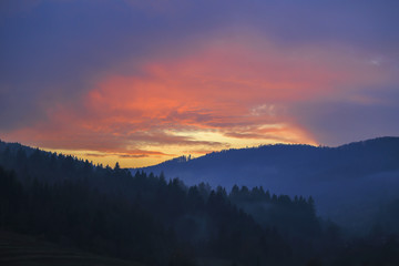 Carpathian evening landscape. Majestic sunset in the mountains landscape with sunny beams. Dramatic scene. Carpathian, Ukraine, Europe. 