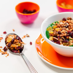 fresh greens and granola smoothie on white table. Healthy vegan food.