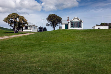 Fototapeta na wymiar Historic schoolbuilding and barn on the hill Catlins New Zealand.