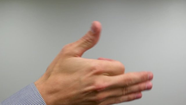Single Hand Shadow Puppet of a Dog with Caucasian Middle-Aged Male Hand in Dress Shirt