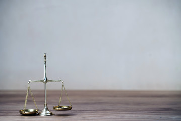 Law scales on wooden desk concept for justice and equality