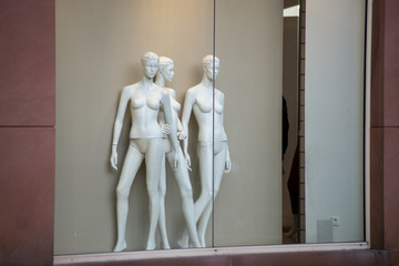 Closeup of nude mannequins in a fashion store showroom during the black friday