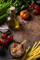 Italian cuisine background on dark rustic background, top view