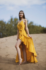 Attractive girl in the yellow dress