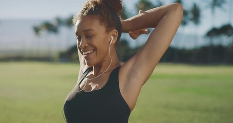 Portrait of a young active african american woman smiling and stretching before her morning workout, happy attractive woman living a healthy lifestyle - Powered by Adobe