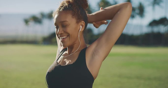 Portrait of a young active african american woman smiling and stretching before her morning workout, happy attractive woman living a healthy lifestyle