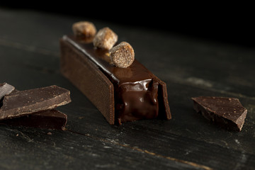 Chocolate cake between two buiscuits with streusel decoration