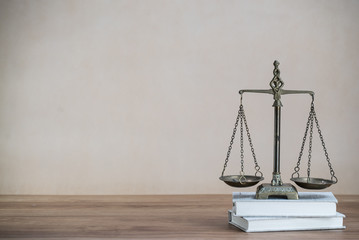 Law scales on wooden desk concept for justice and equality - 321019971