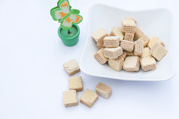 Cube wafers served in a bowl on white background