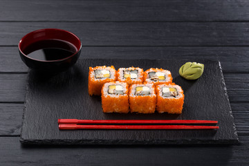 Sushi set. maki, gunkan and sushi rolls served on stone slate. Sushi set on a stone plate and dark concrete background. Sushi roll set and chopsticks. Fresh Japanese cuisine. asian food. Sushi image f