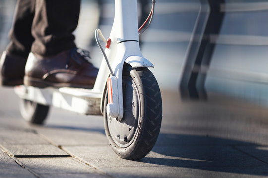 Young Businessman On E Scooter In The City