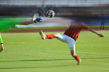 Two men play football. Color image. To enhance the effect of the movie, motion blur was added. Copy...