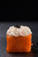 Gunkans spicy salmon on a dark background. Close up view on gunkan sushi with spicy sauce. Fresh Japanese cuisine. asian food. Sushi image for menu. sushi set on a black plate isolated on dark 