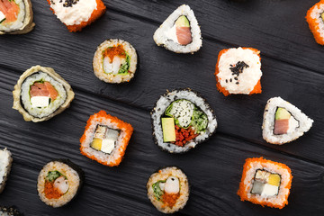 Sushi set. maki, gunkan and sushi rolls served on stone slate. Sushi set on a stone plate and dark concrete background. Sushi roll set and chopsticks. Fresh Japanese cuisine. asian food. Sushi image f