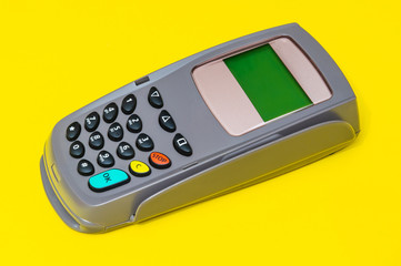 Business still life payment terminal for receiving money on yellow office desk