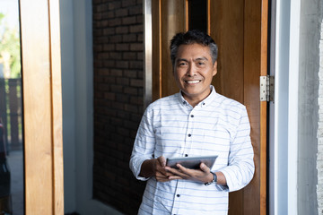 asian mature businessman using tablet pc. connect trough technology
