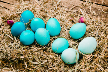Ten easter eggs in blue gradient color design. On a wooden vintage background..