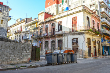 Fototapeta na wymiar Colorful street in Havana with houses and garbage bins
