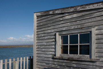 Fototapeta na wymiar Okarita South island coast. New Zealand. Historic Jetty. Wooden shed.