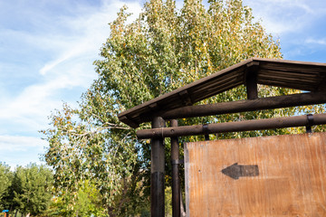 Blank wooden signpost in a forest, space for copy text.