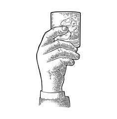 Male hand holding glass whiskey. Vintage vector engraving